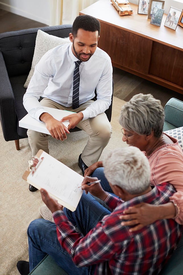 American Pace employee assisting an elderly community member with paperwork